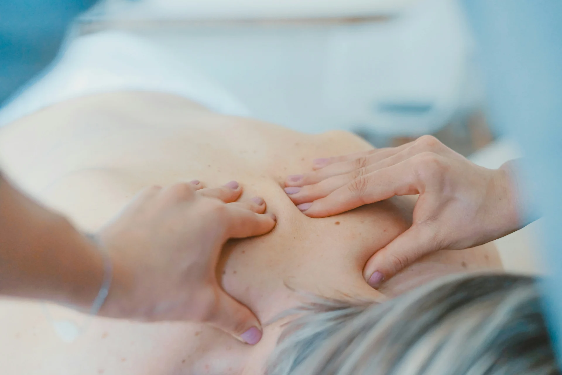 Massage therapist working on a patient's shoulder blade